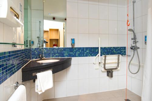a bathroom with a shower and a sink at Holiday Inn Express Hemel Hempstead, an IHG Hotel in Hemel Hempstead