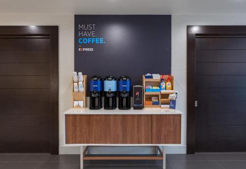 a counter with bottles of coffee on top of it at Holiday Inn Express & Suites - San Marcos South by IHG in San Marcos