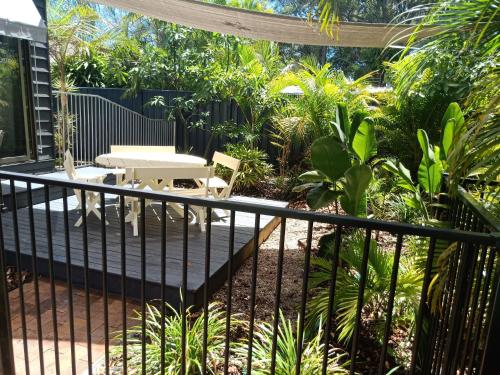 a patio with a table and a fence at Licence to Chill on Bribie in Bongaree