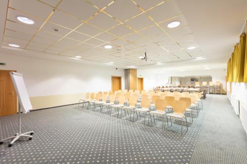 a room with rows of chairs and a podium in it at Hotel Andreas Hofer in Sankt Leonhard im Pitztal