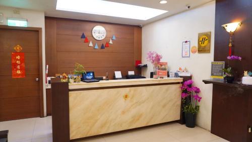 a lobby with a counter with a clock on the wall at Su Ao Hotel in Suao