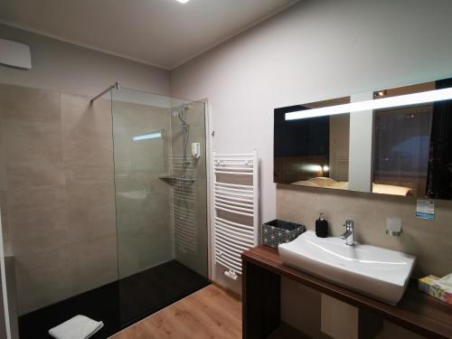 a bathroom with a sink and a shower at Hotel Zu Freunden in Hamm