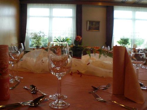 a table with glasses and spoons on top of it at Studtmann's Gasthof in Egestorf