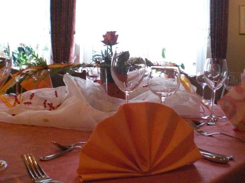 a table with wine glasses on top of it at Studtmann's Gasthof in Egestorf