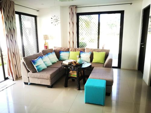 a living room with a couch and a table at Casa Herminia Baler in Baler