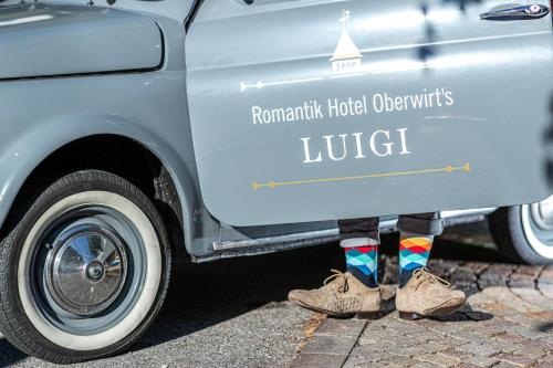 a person is standing in front of a truck at Romantik Hotel Oberwirt in Marlengo