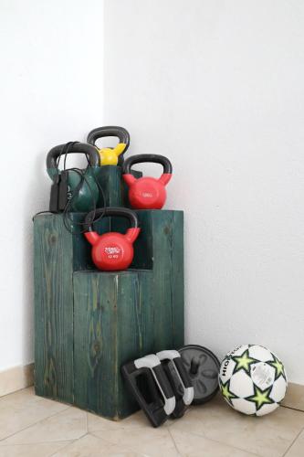 a wooden box with three pitchers and a soccer ball at Apartment Zanov in Preko