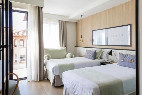 מיטה או מיטות בחדר ב-Ars Magna Bleisure Hotel