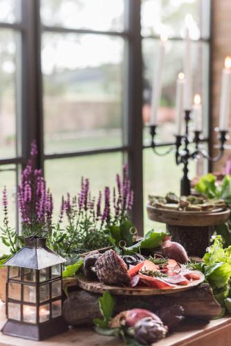 a table with a plate of food on a table at Relais Sant'Elena in Bibbona