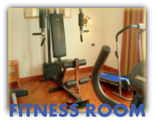 a gym with a fitness room with exercise equipment at Hotel Beau Sejour in Etroubles