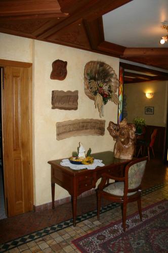 a living room with a table and a chair at Hotel Beau Sejour in Etroubles