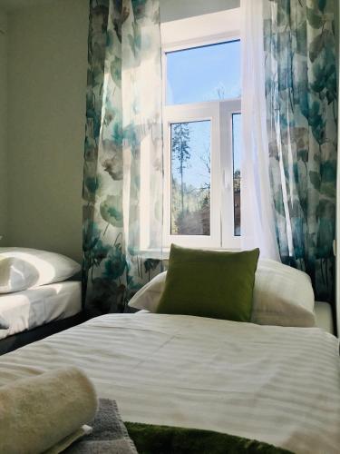 a bedroom with a bed and a window and a sink at Gościniec Kowalova in Mieroszów