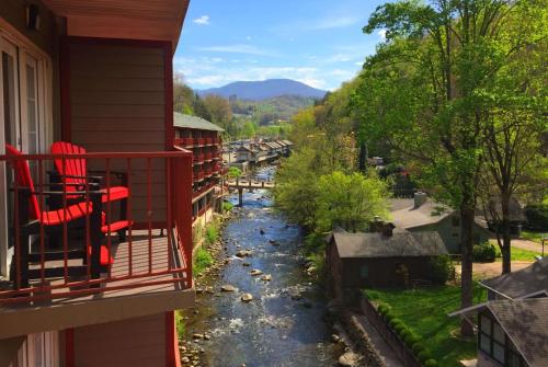 a view of a river from the balcony of a house at Baymont by Wyndham Gatlinburg On The River in Gatlinburg