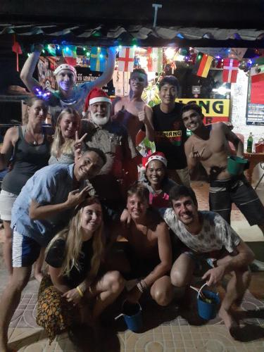 a group of people posing for a picture at a party at Hangover Hostel in Phi Phi Don