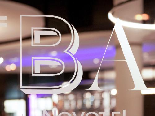 a close up of a sign for a store at Novotel Basel City in Basel