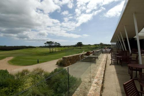 a view of a golf course from the balcony of a building at Peppers Moonah Links Resort in Fingal