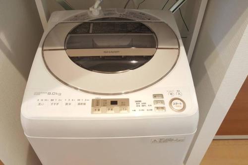 a washing machine is sitting in a room at CuteFamilyHouse! 3LDK 6minShinjuku 3minJRsta Cozy,Fun,Bright! KidsFree Under6yrs in Tokyo