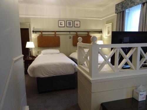 a small bedroom with a bed and a window at The Belmore in Sale