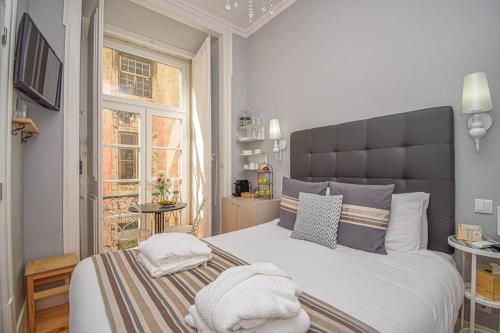 a bedroom with a large bed and a window at B in B Lisbon Downtown Suites in Lisbon