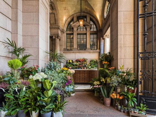 a store filled with lots of flowers and plants at Kimpton Clocktower by IHG in Manchester