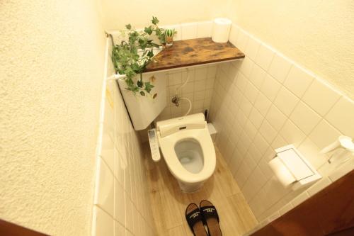 a small bathroom with a toilet in a stall at 群青の間 in Okayama