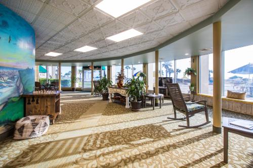 a living room filled with furniture and a large window at Days Inn & Suites by Wyndham Jekyll Island in Jekyll Island