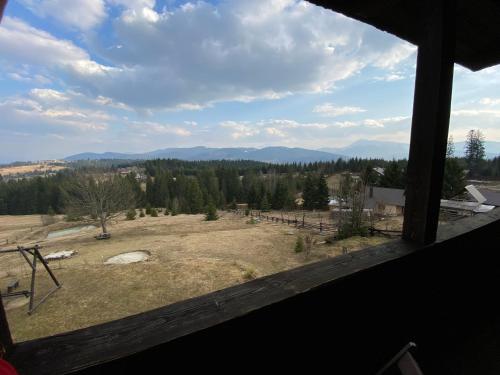 a view of a field from a window at Blyzhche Neba in Yablunytsya