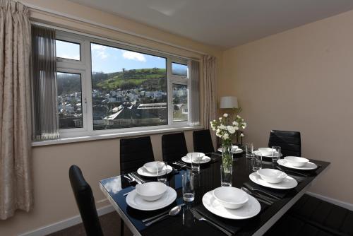 a dining room with a table and a large window at Riverside 6 in Dartmouth