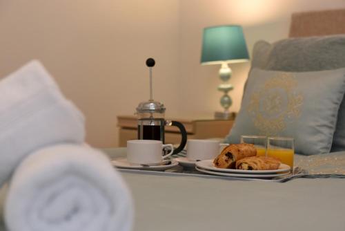 a table with a tray of food and coffee and drinks at The Mews in Dartmouth