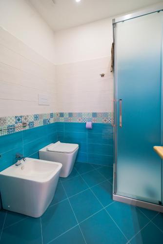 a bathroom with a toilet and a sink and a shower at Perla di Mare Appartamenti in Castelluzzo