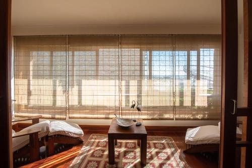 a living room with a large window and a table at Apartamento Portas do Mar I in Matosinhos