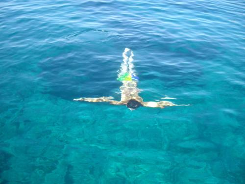 a person is swimming in the water at Costa Paradiso Resort in Costa Paradiso
