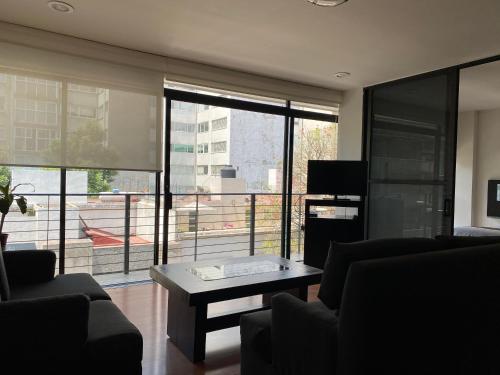 a living room with a couch and a coffee table at Grupo Kings Suites -Platon 436 in Mexico City