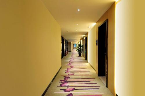 a long hallway with pink petals on the floor at Lavande Hotels·Guiyaung North Railway Station in Guiyang