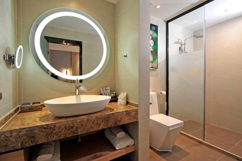 a bathroom with a sink and a mirror at Lavande Hotels·Guiyaung North Railway Station in Guiyang