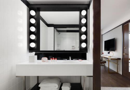 a bathroom with a sink and a mirror at TWA Hotel at JFK Airport in Queens