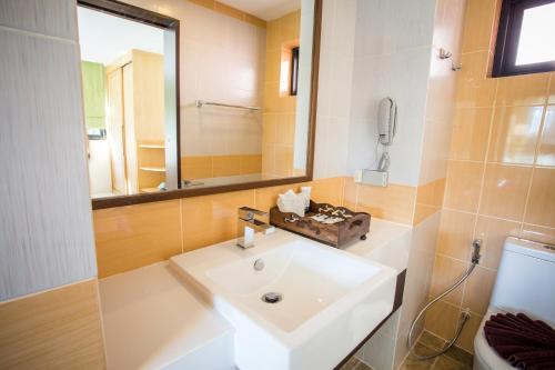 a bathroom with a white sink and a mirror at Studio apartments on a hill in Kathu