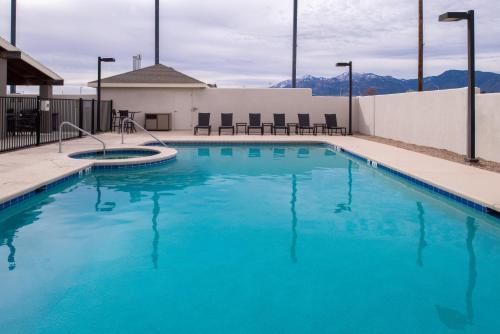 a large swimming pool with blue water at Holiday Inn Express Sierra Vista by IHG in Sierra Vista