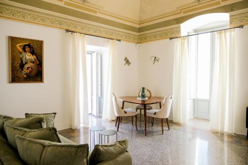 a living room with a table and chairs at Masseria D'Erchia in Monopoli