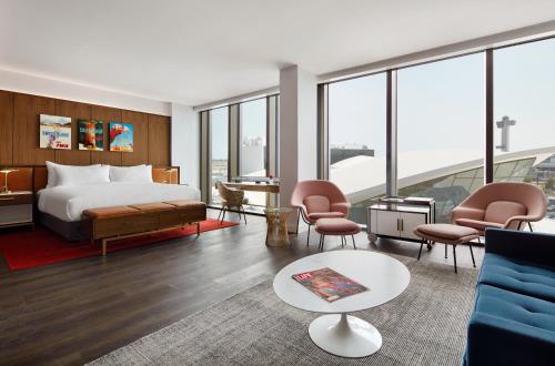 a hotel room with a bed and a couch at TWA Hotel at JFK Airport in Queens