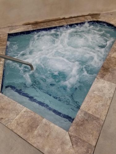 a jacuzzi tub with clouds in the water at Vacation Lodge in Pigeon Forge