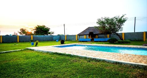a swimming pool in a yard with a house at Sweet Retreat in Lusaka