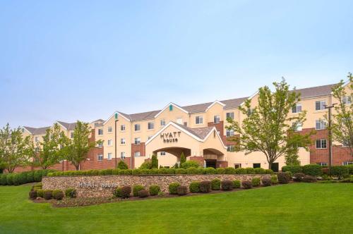 a large building with a lawn in front of it at Hyatt House White Plains in White Plains