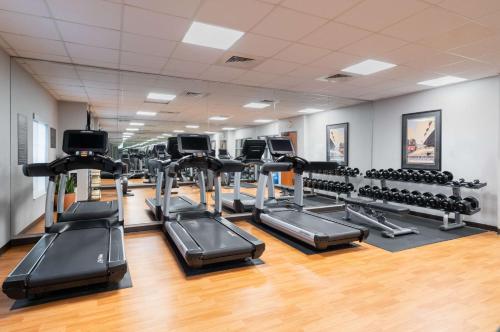 a gym with rows of treadmills and exercise bikes at Hyatt House White Plains in White Plains