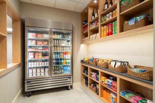 a walk in pantry with a refrigerator and shelves at Hyatt House White Plains in White Plains