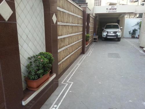 a car parked in a parking lot next to a building at Hotel Ashray International, Sion - Near BKC in Mumbai