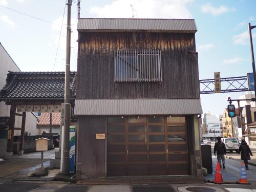 a building with a large door on a street at Ninja TABI-NE in Kanazawa