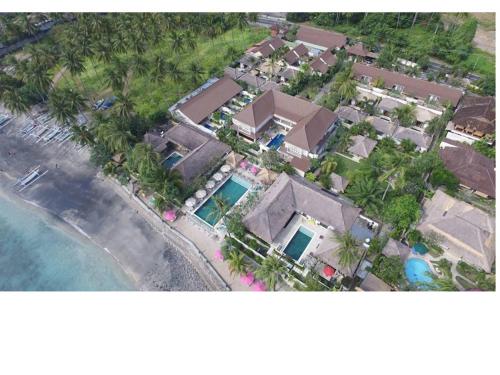 an aerial view of a house next to the ocean at Puri Mas Boutique Resort & Spa in Senggigi