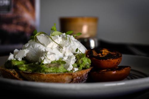 a plate with a piece of bread with food on it at The Charles in Wagga Wagga