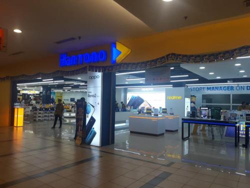 a store with a sign on the wall in a mall at Choice City Hotel in Surabaya